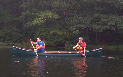 Novice canoeists work in tandem to match stroke cadence