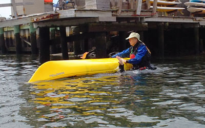 Beginning kayakers are invited to perform a wet-exit with Instructor support